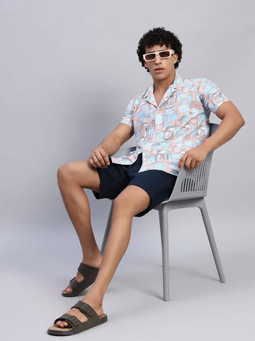 Full look: Men's multicolor abstract graphic shirt styled with navy shorts, sunglasses, and sandals — SMOKHEAD summer casual streetwear outfit