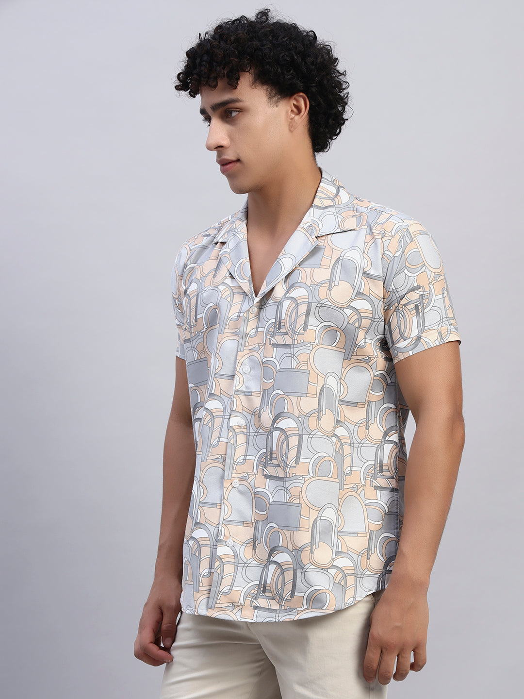 Left side profile of men’s beige and pastel abstract graphic print short-sleeve shirt — SMOKHEAD relaxed resortwear