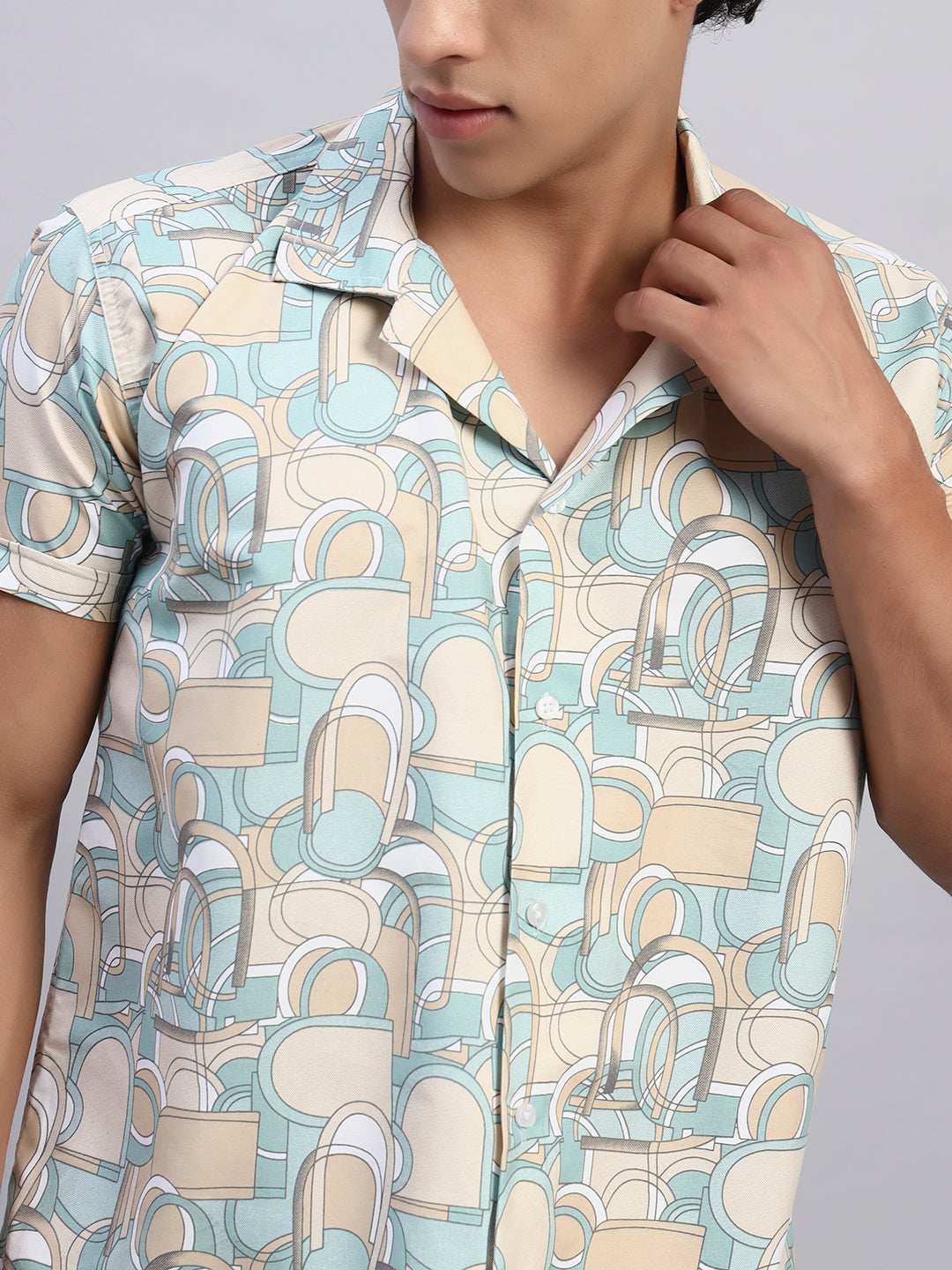 Close-up of beige and pastel geometric abstract pattern fabric on men’s short-sleeve shirt — SMOKHEAD premium fabric detailing