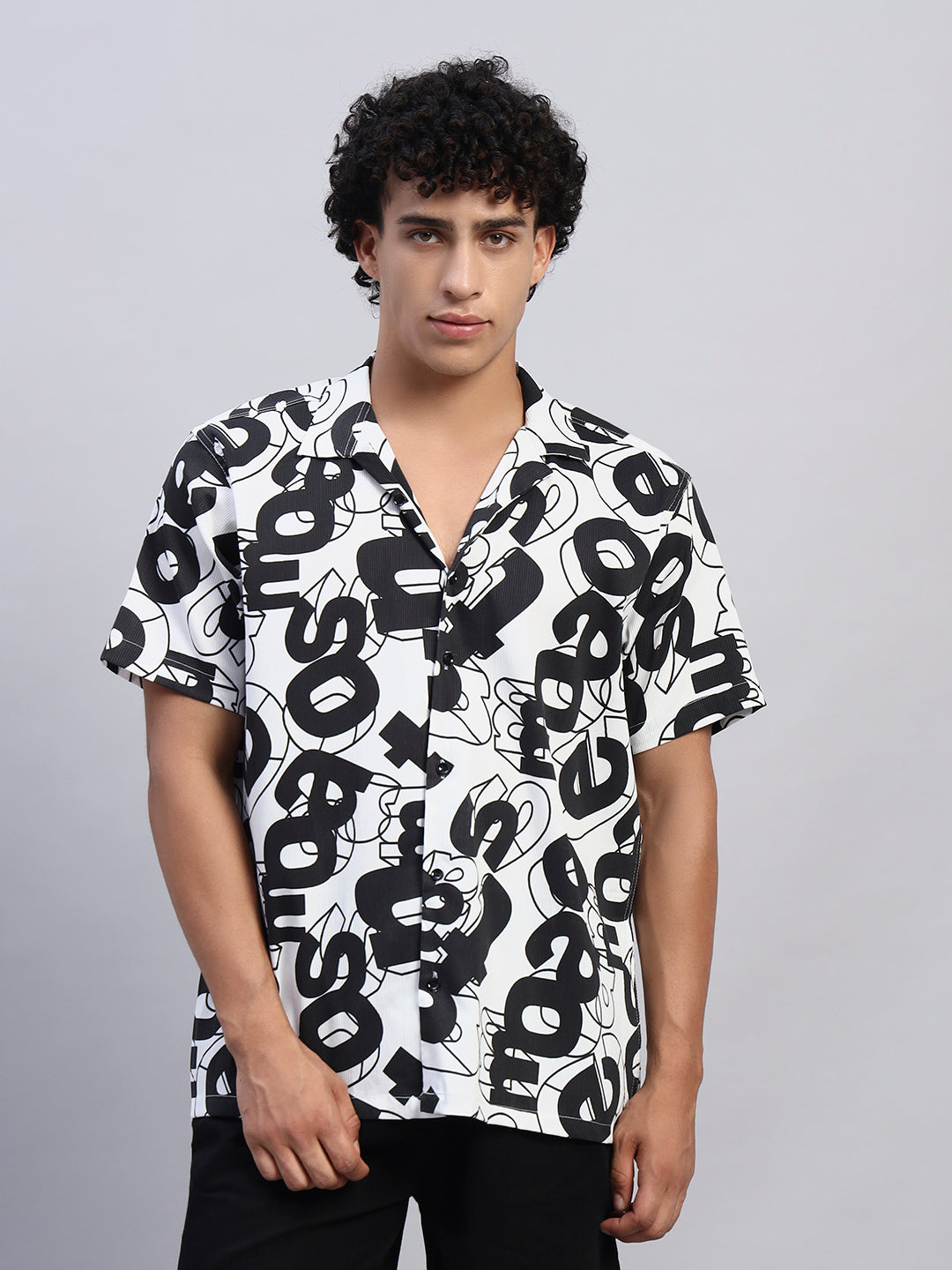 Close-up of black and white abstract graphic print fabric on men's short-sleeve shirt — SMOKHEAD premium streetwear quality