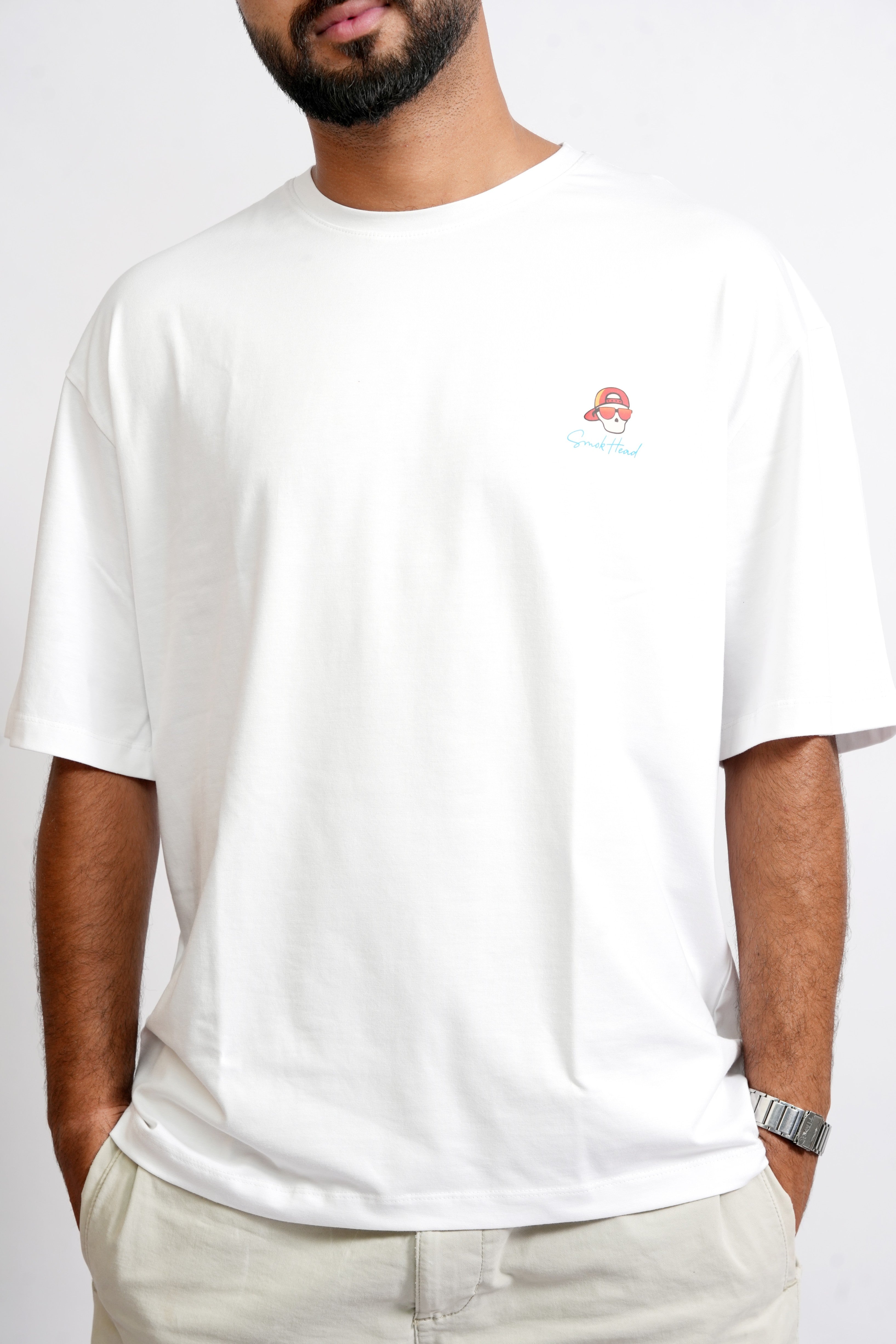 Front View – SMOKHEAD Men's White Oversized T-Shirt with Minimal Red Skull Logo Graphic on Chest